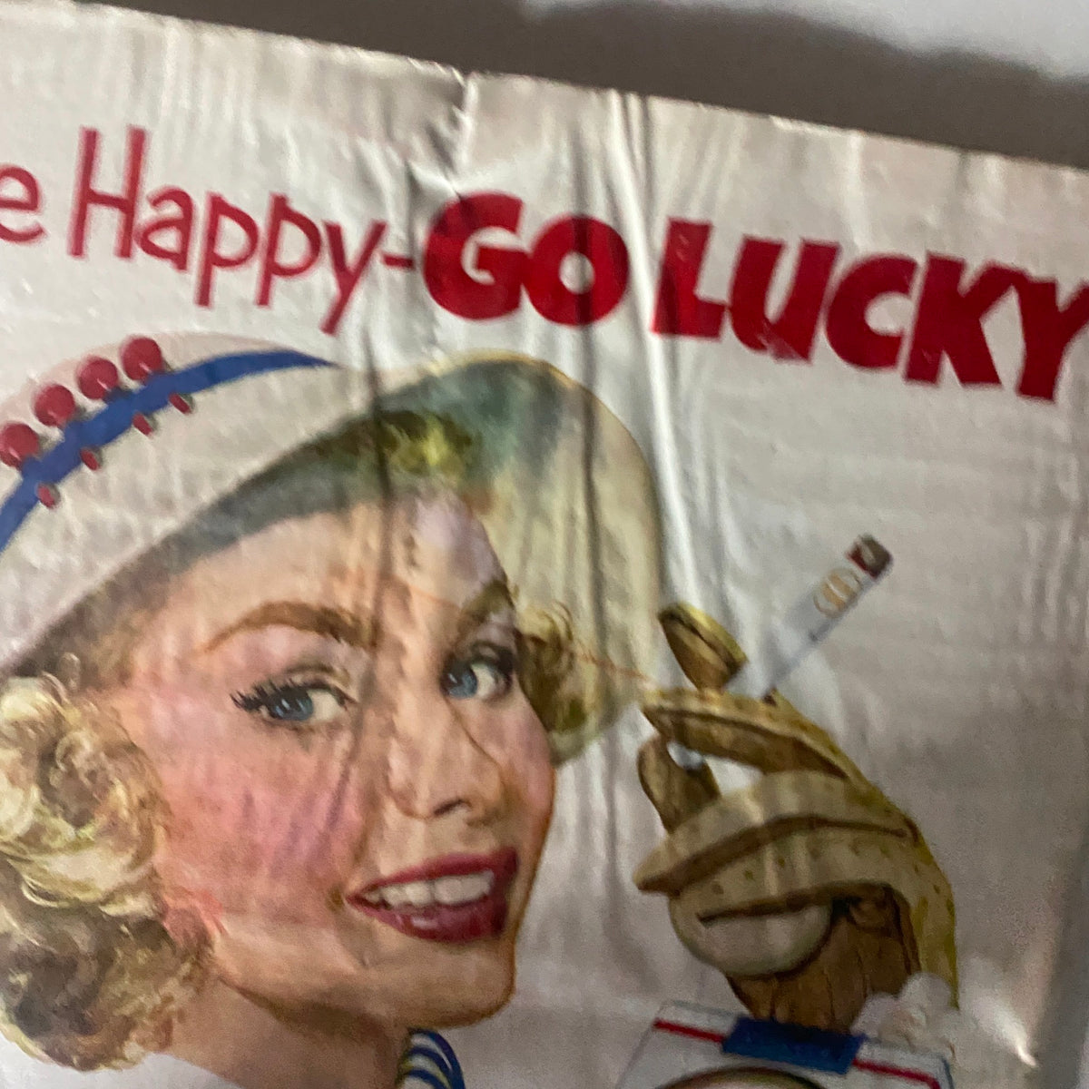 Close-up of the Be Happy-Go Lucky! vintage advertisement showing a glamorous woman smiling, holding a cigarette and a Lucky Strike pack. VTG Time Magazine May 5, 1952 Vol 51 No. 18.