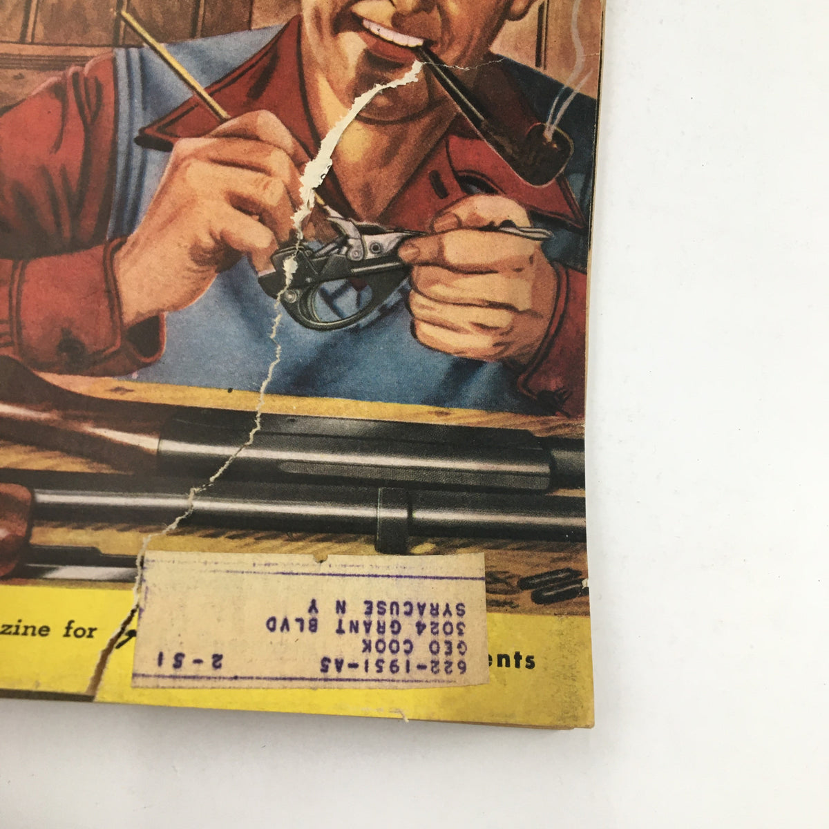 Close-up of the cover of Hunting & Fishing Magazine September 1950 Vol. 27 No. 9, showcasing a man repairing a firearm with visible wear and an address label.