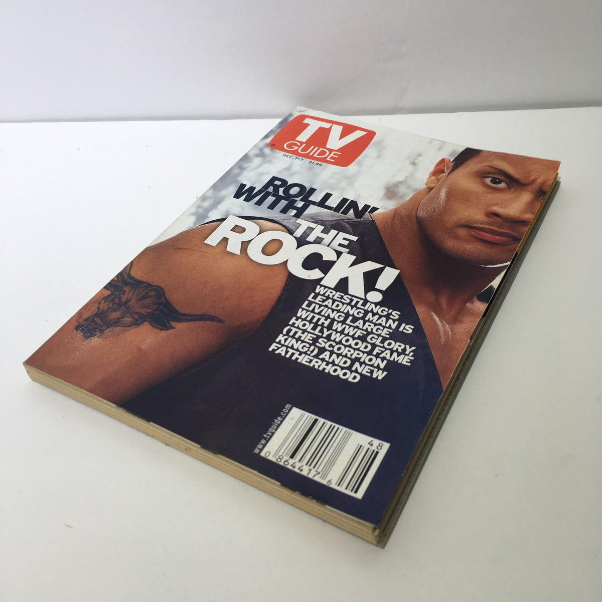 TV Guide Dec 1-7 2001 Rollin' with The Rock, The Scorpion King cover showing the magazine from a side angle, highlighting the spine and cover features.