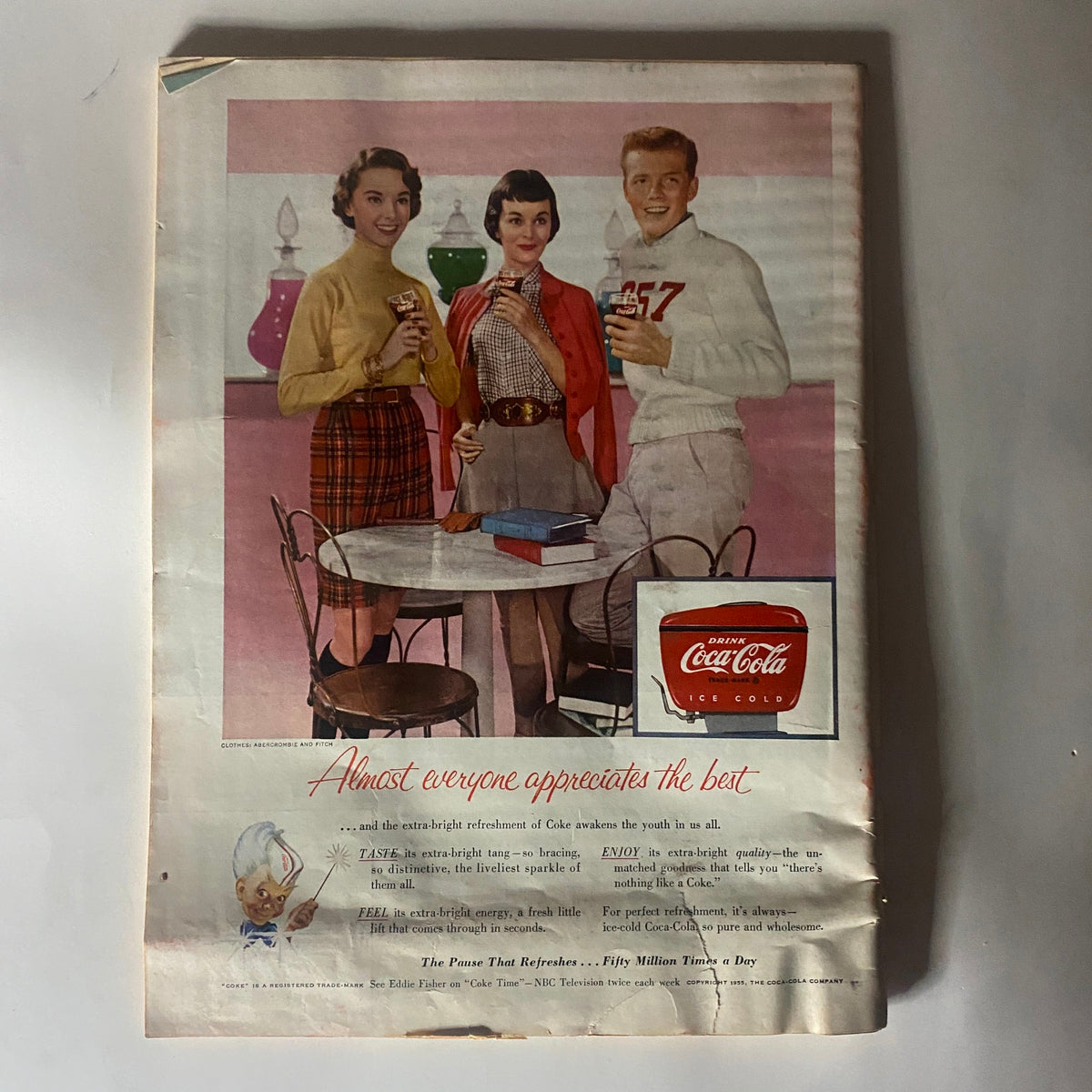 Advertisement page from vintage Time Magazine dated September 12, 1955, showcasing a Coca-Cola ad with three young people enjoying drinks, representing mid-century culture.