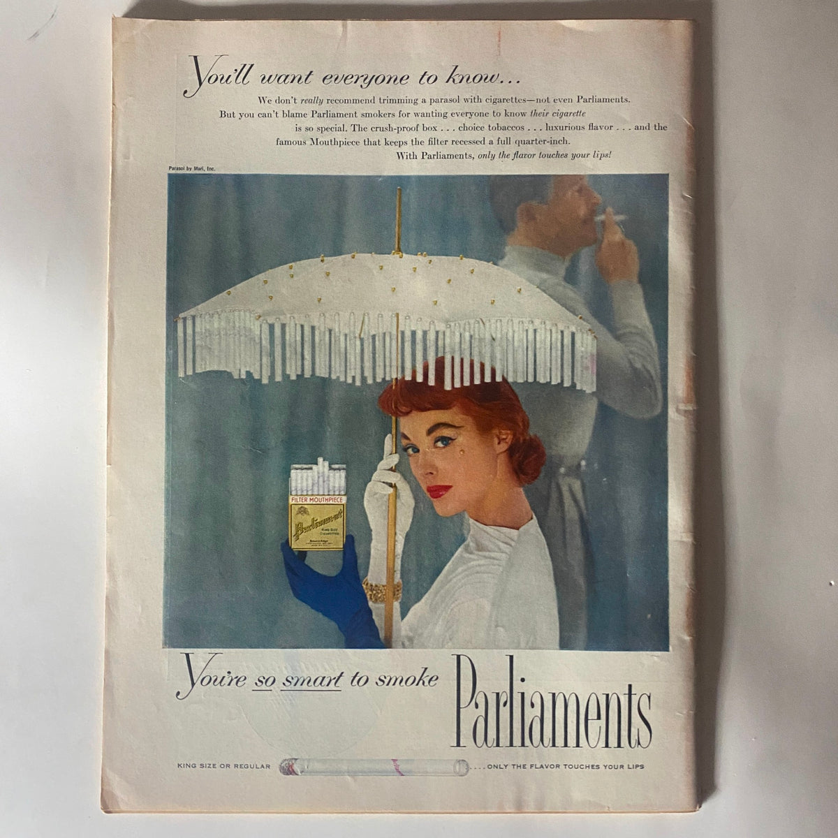 Vintage advertisement featuring a woman holding a pack of Parliaments cigarettes with an umbrella, promoting the brand as part of VTG Time Magazine August 29, 1955 featuring Frank Sinatra on the cover.