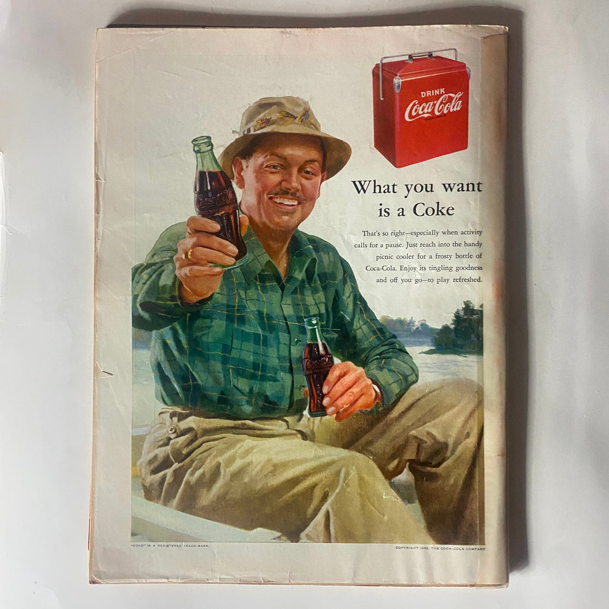 Advertisement from the vintage Time Magazine June 9, 1952 (Vol 59 No. 23) featuring a smiling man holding a Coca-Cola bottle, promoting refreshment during outdoor activities.