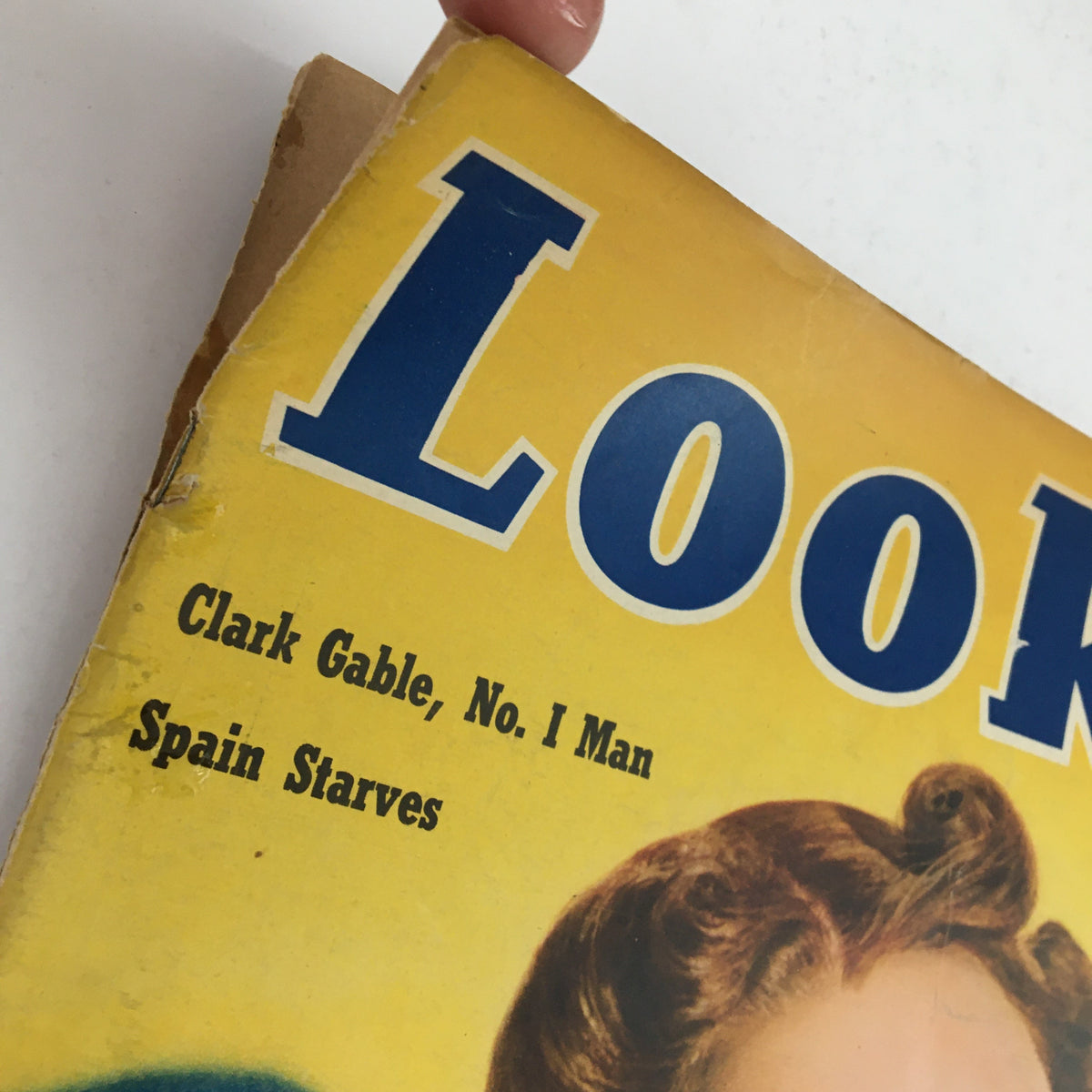 Close-up view of the Look Magazine February 14, 1939 title. Highlights the prominent text 'Clark Gable, No. I Man' and 'Spain Starves', set against a vibrant yellow background, reflecting the vintage aesthetic of the 1930s.
