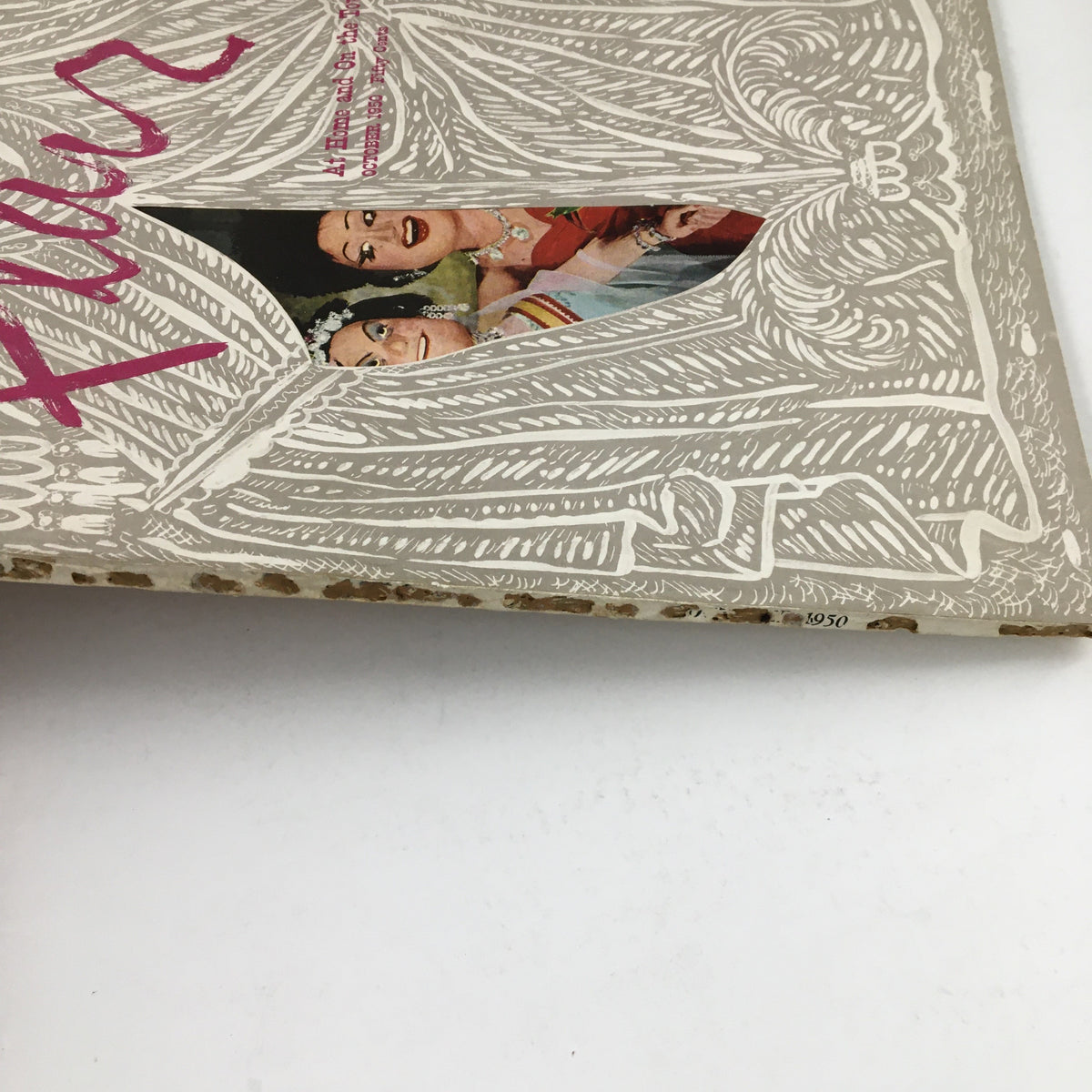 Side view of Flair Magazine October 1950 titled 'At Home and On The Town', showcasing the vintage cover design with artistic details.