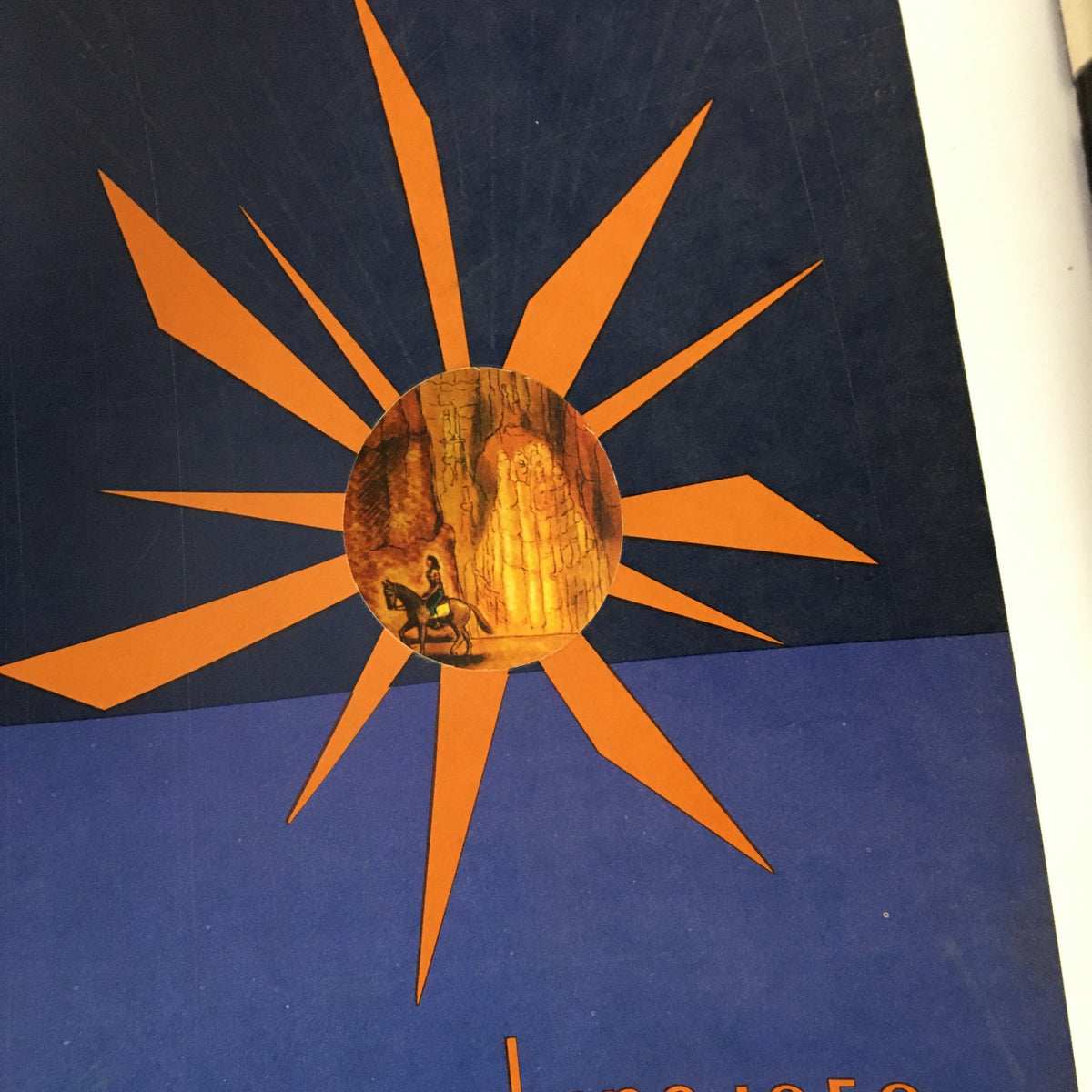 Cover design of Flair Magazine June 1950 featuring a sunburst graphic and an artistic representation of a person on horseback, symbolizing summer and travel themes.