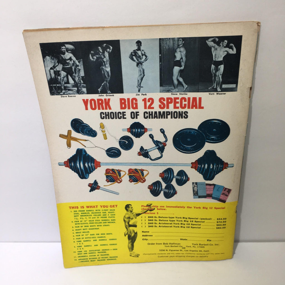 Back cover of Muscular Development Magazine featuring the York Big 12 Special, showcasing various weightlifting equipment and images of bodybuilders such as Steve Reeves and John Grimek.