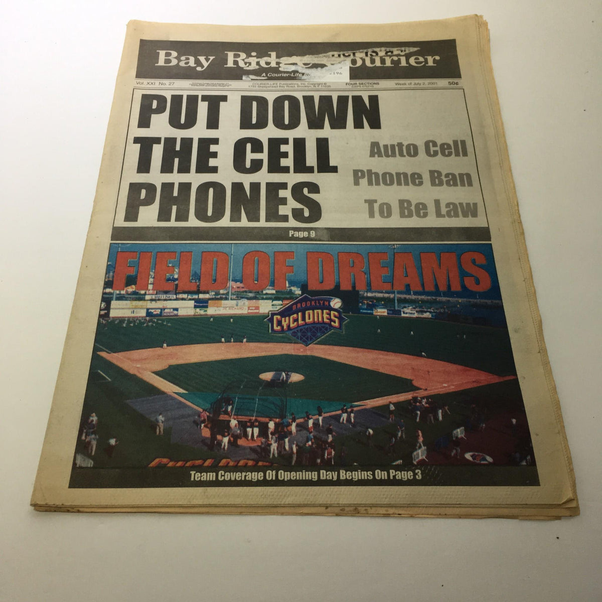 Image of the Bay Ridge Courier newspaper featuring the headline 'PUT DOWN THE CELL PHONES' and a cover story about the cell phone ban, along with an image of the Field of Dreams baseball stadium for the Brooklyn Cyclones, dated July 2, 2001.