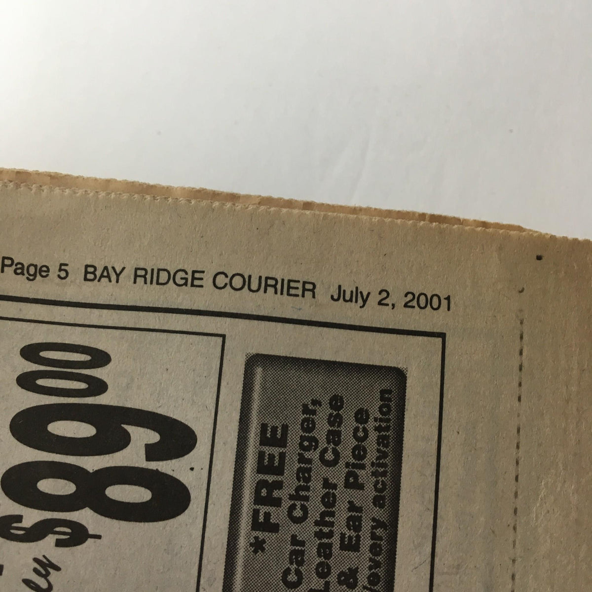 Close-up detail of a Bay Ridge Courier newspaper dated July 2, 2001, featuring news related to the article 'PUT DOWN THE CELL PHONES' from A Courier Life Publications.
