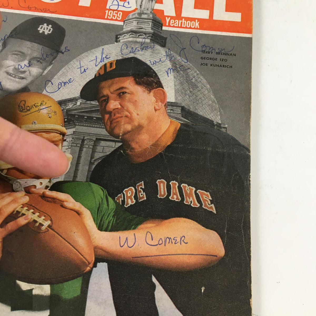 Detailed view of the Street & Smith's Football 1959 Yearbook cover, illustrating player interactions and autographs, reflecting the nostalgia of vintage football.