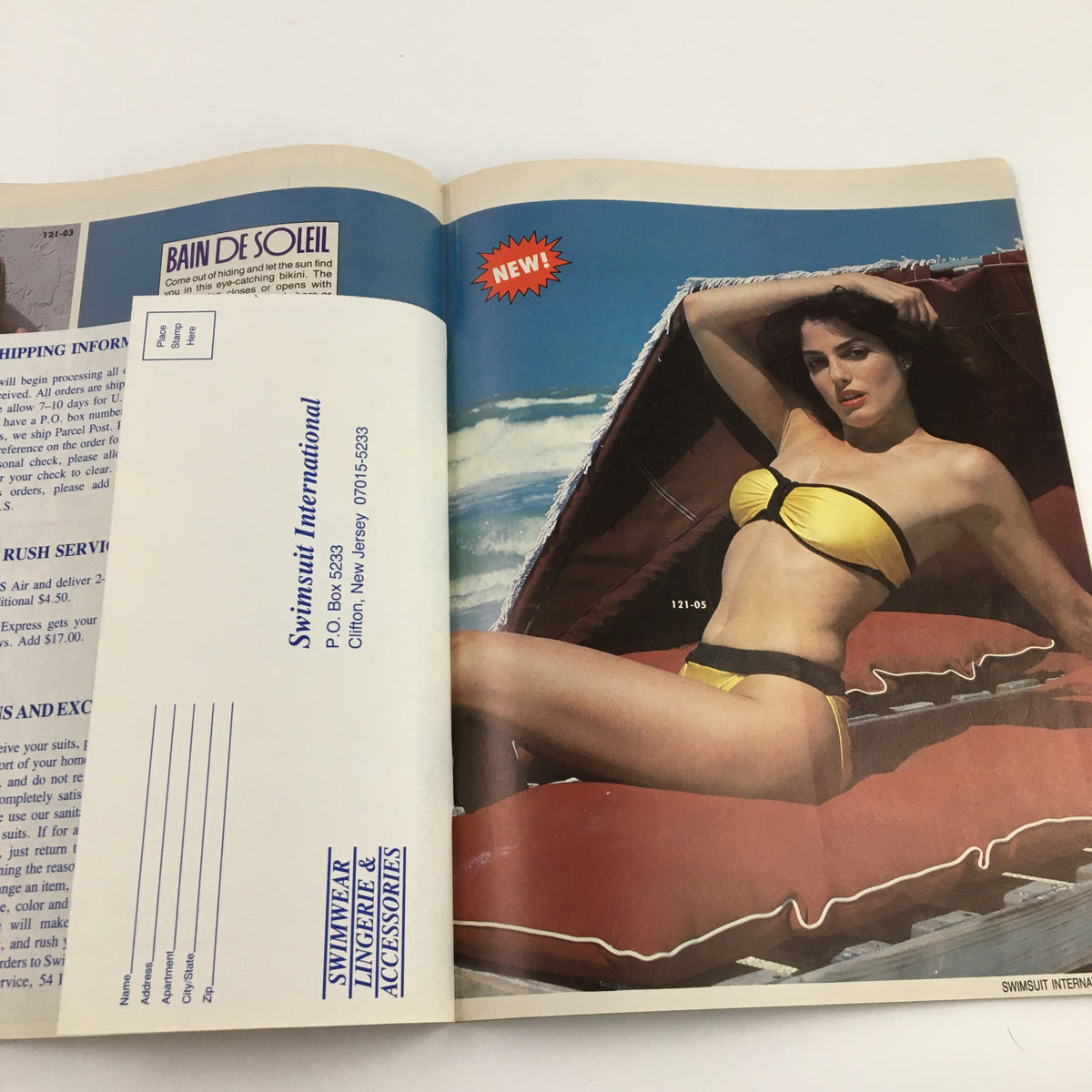 Product advertisement page from Swimsuit International Magazine, October 1987, featuring a model in a yellow bikini lounging on a beach, promoting swimwear alongside magazine subscription information.