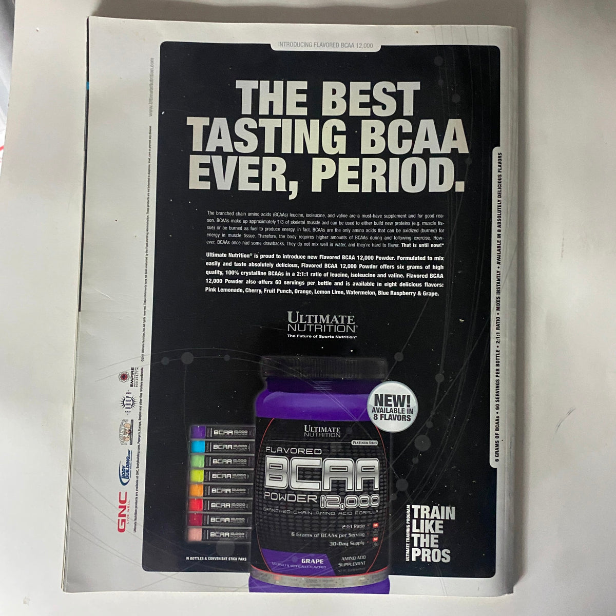 Back cover advertisement for Ultimate Nutrition's BCAA, featuring bold text and product image, accompanying the Train Hard-Fight Easy Magazine December 2011.