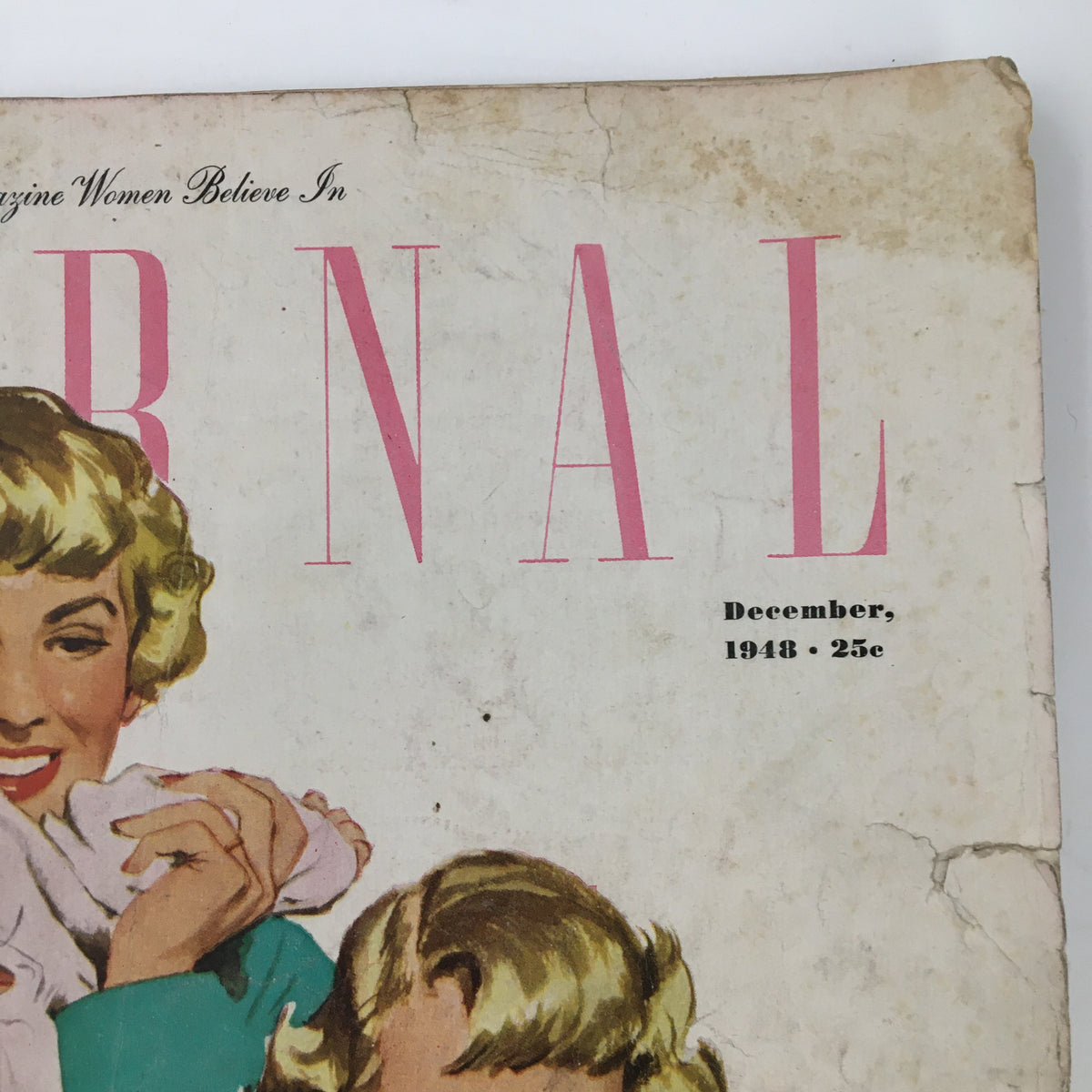 Detailed view of the title block of Ladies' Home Journal Magazine December 1948, showcasing the magazine's name and date with some age-related marks.
