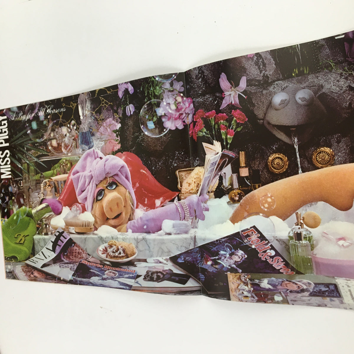 Jim Henson's Muppets Present The Miss Piggy Cover Girl Fantasy Calendar 1981. Page featuring Miss Piggy relaxing in a bubble bath surrounded by luxurious items, illustrating a spa theme.