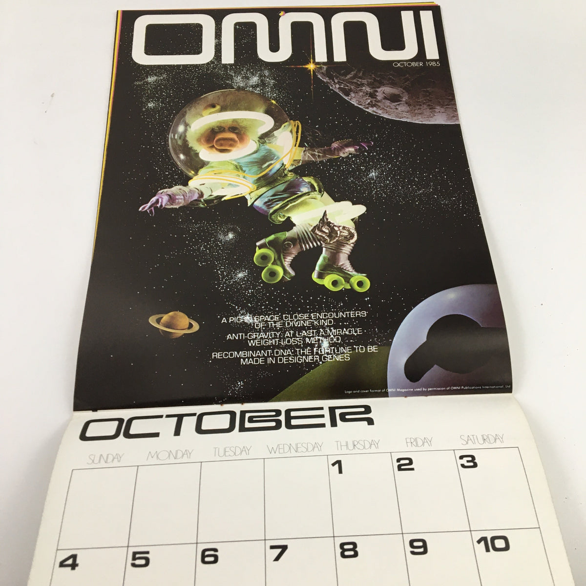 Jim Henson's Muppets Present The Miss Piggy Cover Girl Fantasy Calendar 1981, featuring a retro styled magazine cover with a pig dressed in a space suit, roller skating against a cosmic background for October 1985.