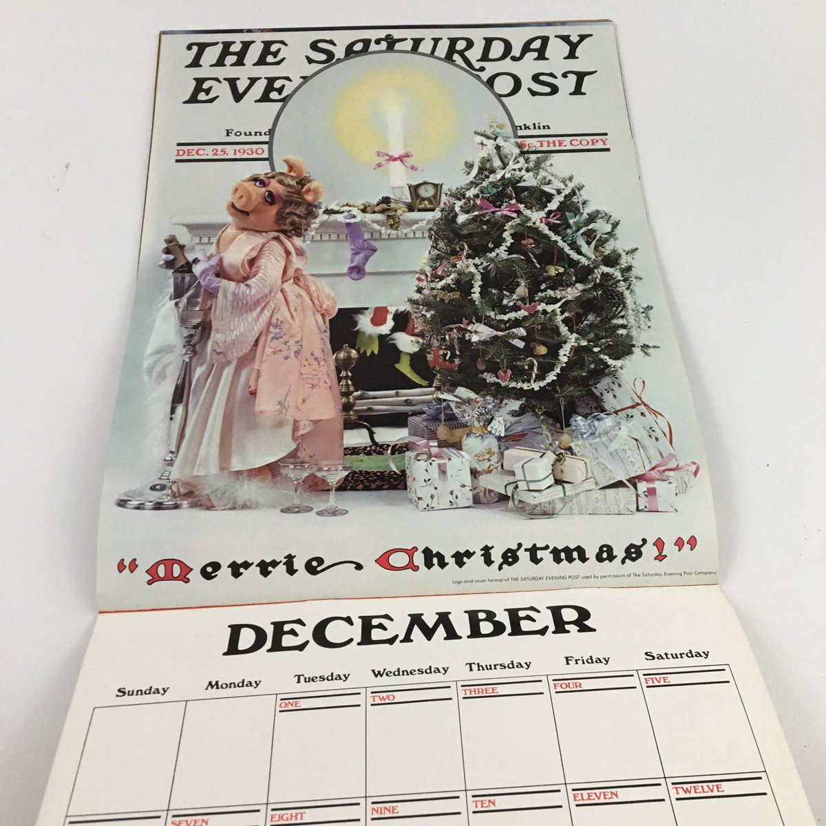 Jim Henson's Muppets Present The Miss Piggy Cover Girl Fantasy Calendar 1981, depicting a nostalgic magazine cover of Miss Piggy beside a Christmas tree, celebrating the holiday season for December.
