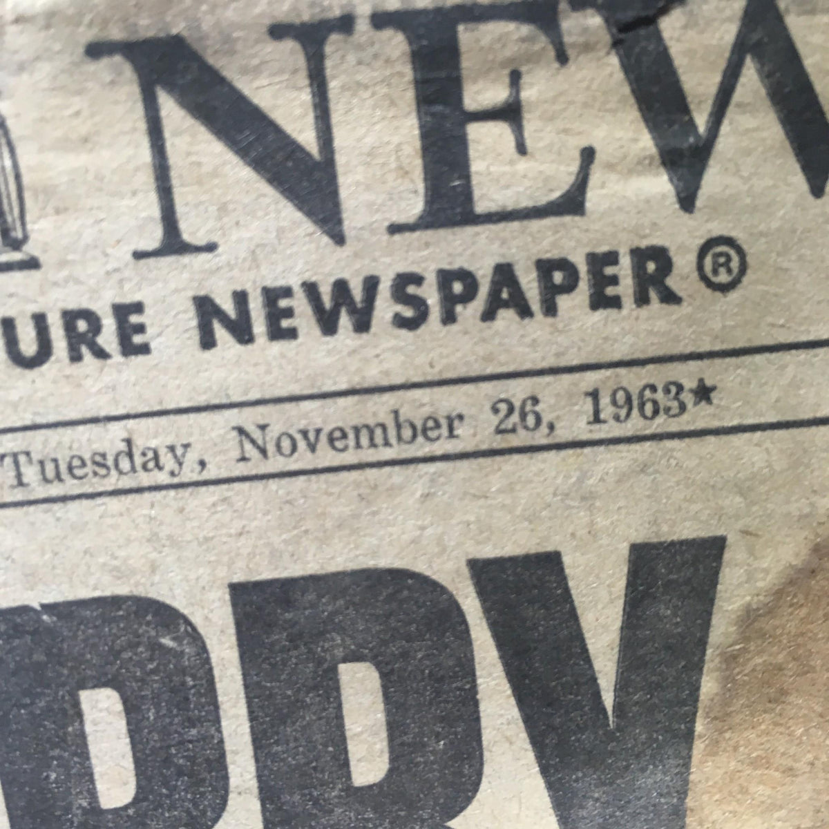 Close-up of the Vintage NY Daily News from November 26, 1963, showing the publication date along with the title 'We Carry On,' marking a historic moment in American history.