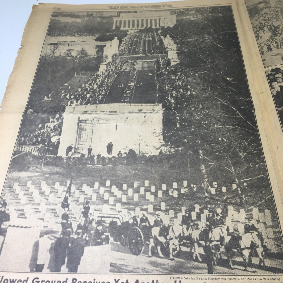 Vintage NY Daily News from November 26, 1963 depicting a solemn aerial view of the JFK funeral procession near Arlington Cemetery, illustrating the massive turnout to honor the late president.