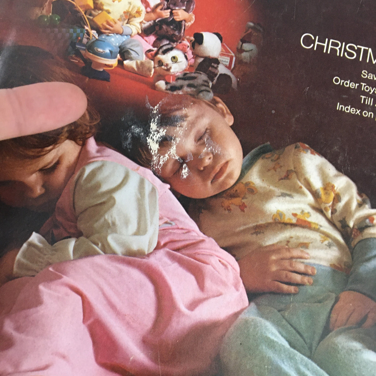 Close-up of the cover page of the 1972 JCPenney Christmas Toys and Giftwares Price Guide Catalog, highlighting the faded yet charming imagery of children and toys.