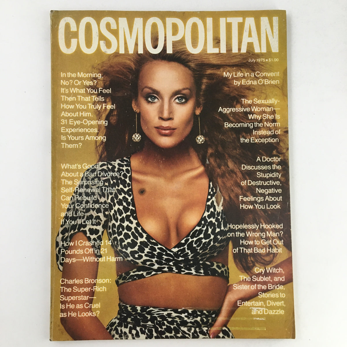 Cover of Cosmopolitan Magazine July 1975 featuring Jerry Hall in a leopard print outfit with bold headlines discussing cultural topics and lifestyle.