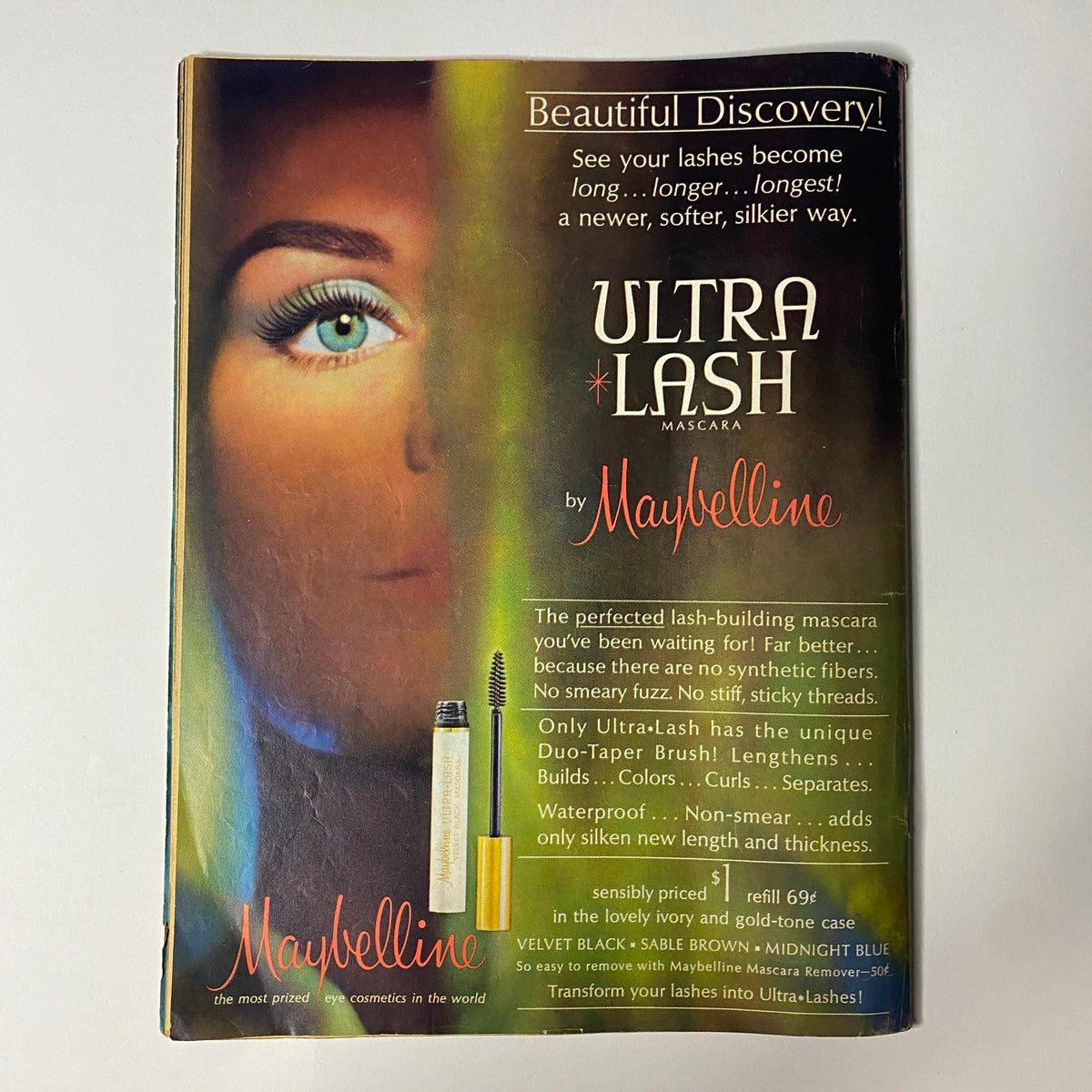 Advertisement for Ultra-Lash Mascara by Maybelline featured in a publication, showcasing a model showcasing lashes with a close-up of an eye. Promising to transform lashes into Ultra-Lash with its unique formula.