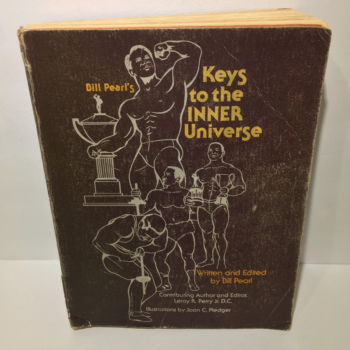 Cover of 'Keys to the Inner Universe Vol. 1 1980 Third Printing by Bill Pearl' showing illustrations of bodybuilders and the title prominently displayed.