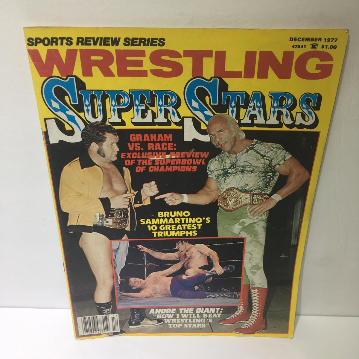 Sports Review Series: Wrestling Super Stars December 1977 magazine cover featuring a wrestling match between Graham and Race, highlighting the exclusive preview of the Super Bowl of Champions and showcasing iconic wrestling figures.