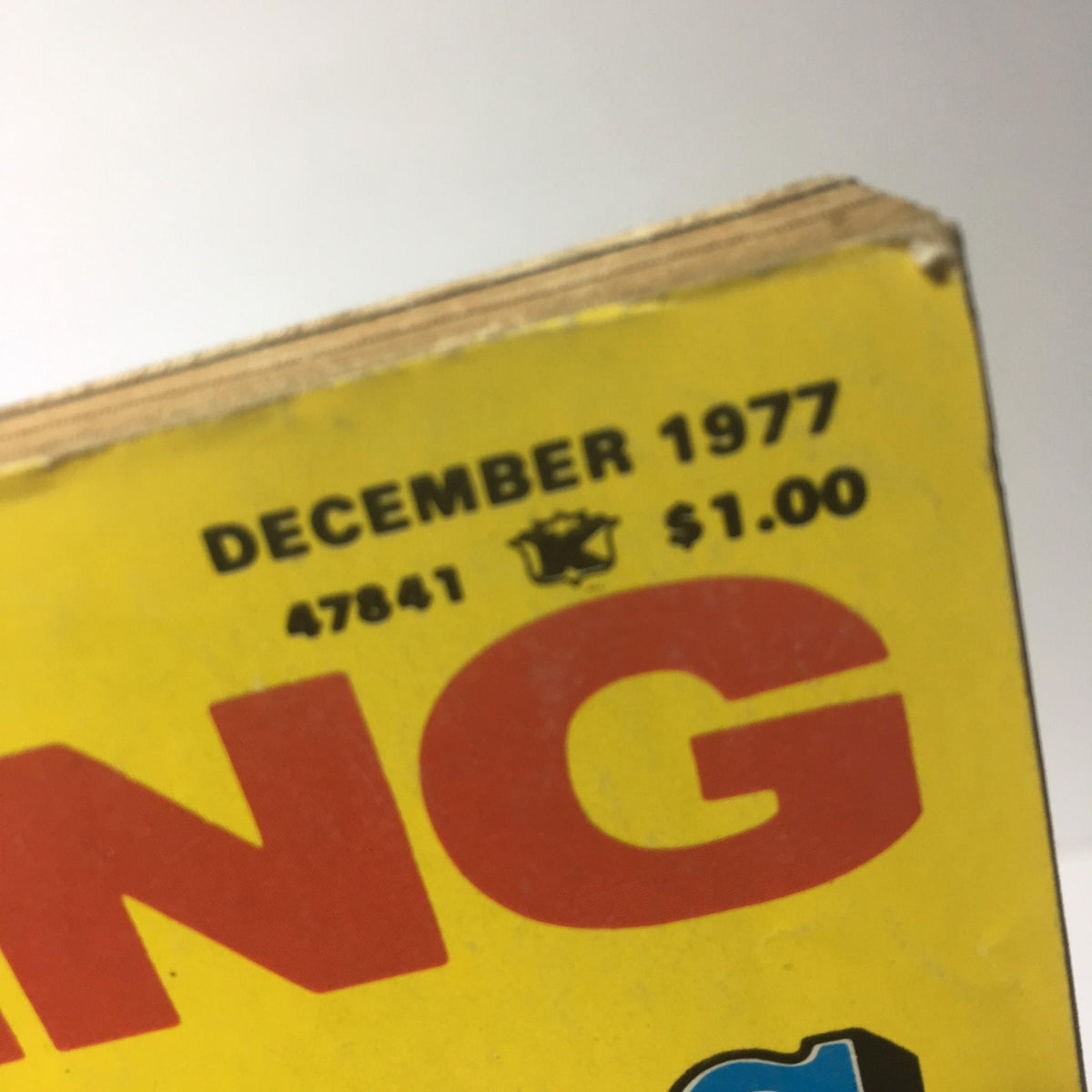 Close-up of the top of the Sports Review Series: Wrestling Super Stars December 1977 magazine showing the publication date and price, emphasizing its vintage appeal as a collectible wrestling magazine.