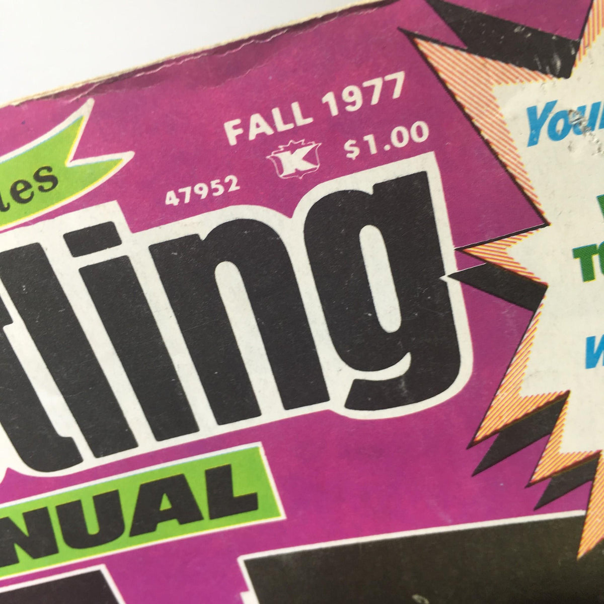Close-up of the title and publication details of the Victory Sports Series: Wrestling Annual - Fall 1977 with vibrant purple and green colors.