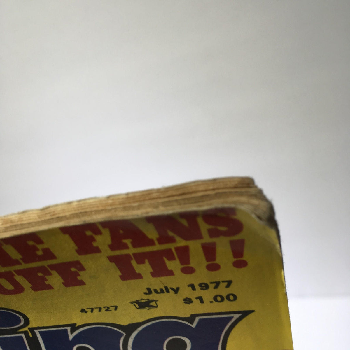 Top view of Inside Wrestling Magazine - Victory Sports Series July 1977 showing the worn edge and age of the pages, demonstrating the magazine's vintage condition.