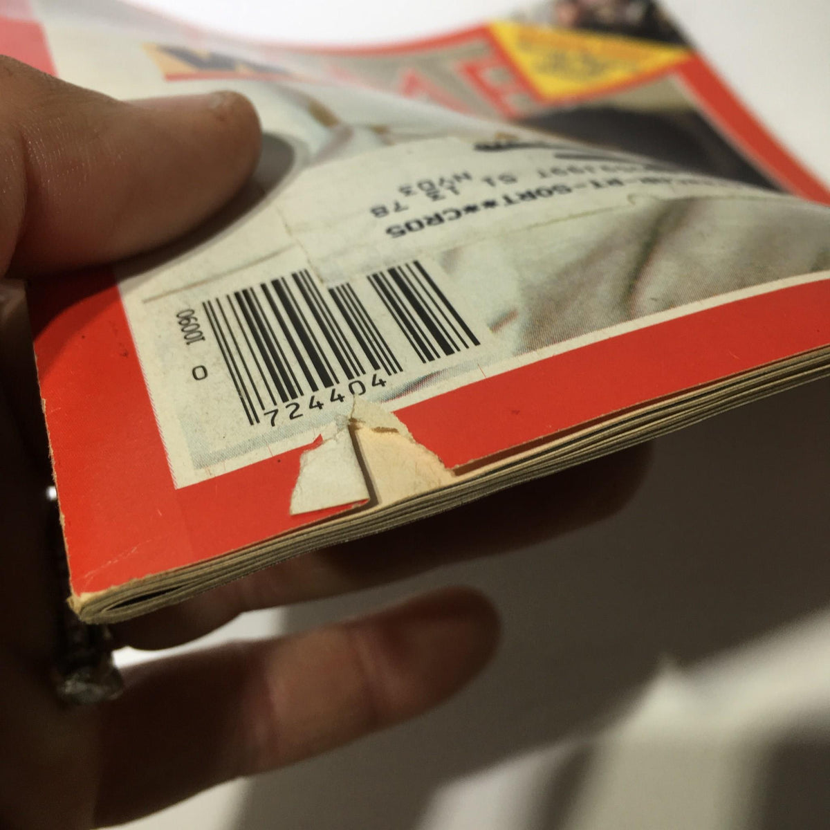 Close-up of the spine of Time Magazine, January 9, 1984, showcasing the barcode and wear on the edges, illustrating its collectible nature as it features the story 'Why Forgive: The Pope Pardons The Gunman'.