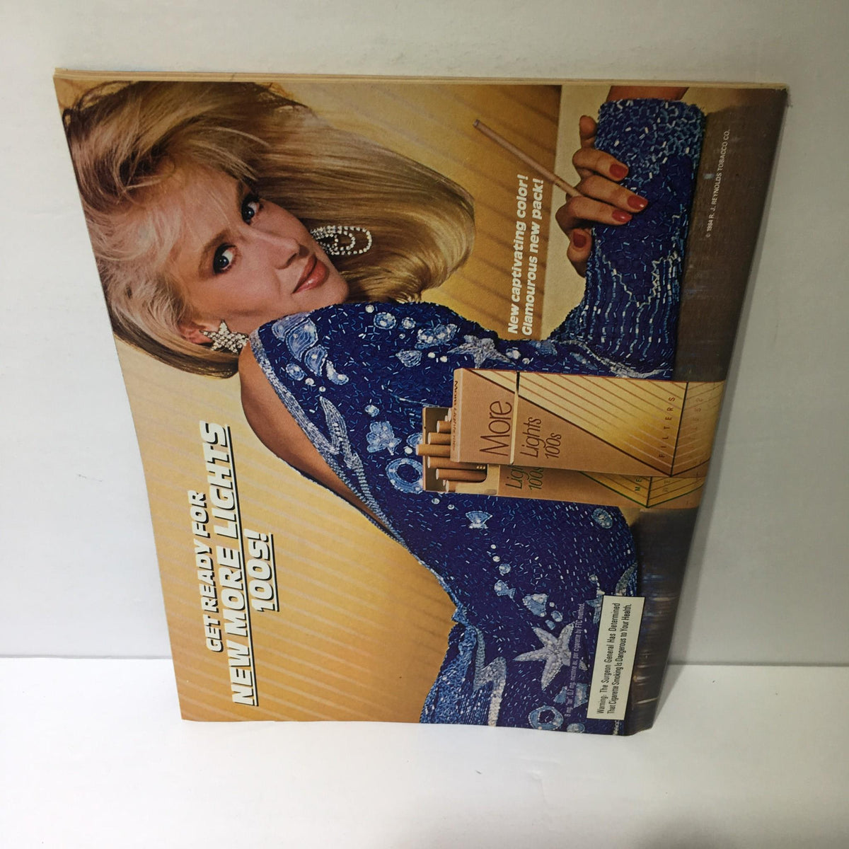 Back cover of Time Magazine dated October 15, 1984, featuring a vintage advertisement with a model wearing a stylish outfit.