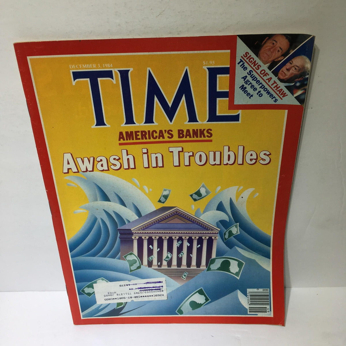 Cover of Time Magazine from December 3, 1984, titled 'America's Banks Awash in Trouble,' featuring a dramatic image of crashing waves and dollar bills, highlighting the banking crisis of the 1980s.