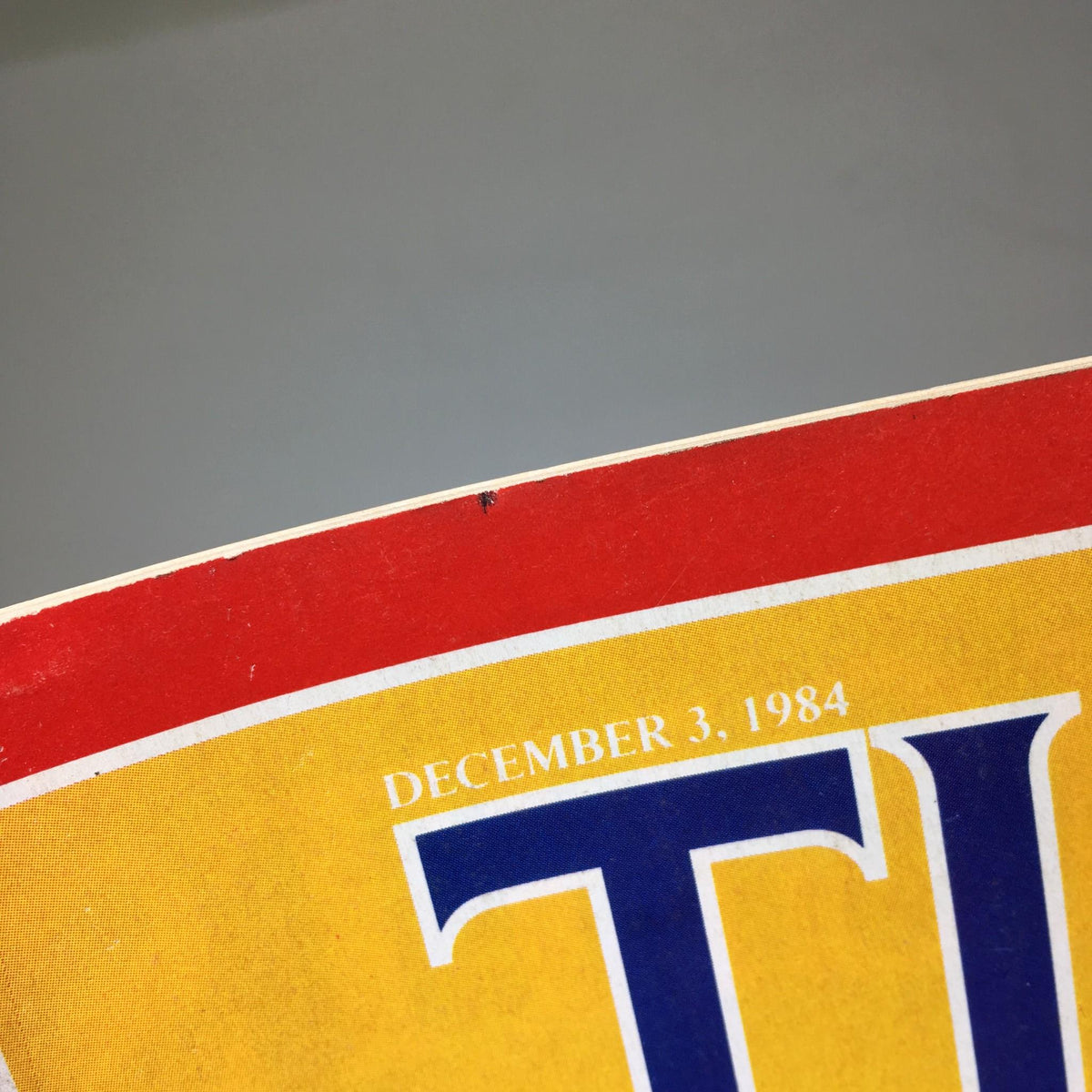 Close-up view of the top of Time Magazine dated December 3, 1984, showcasing the date and the prominent 'TIME' logo, emphasizing its historic significance in discussing America’s banking issues.