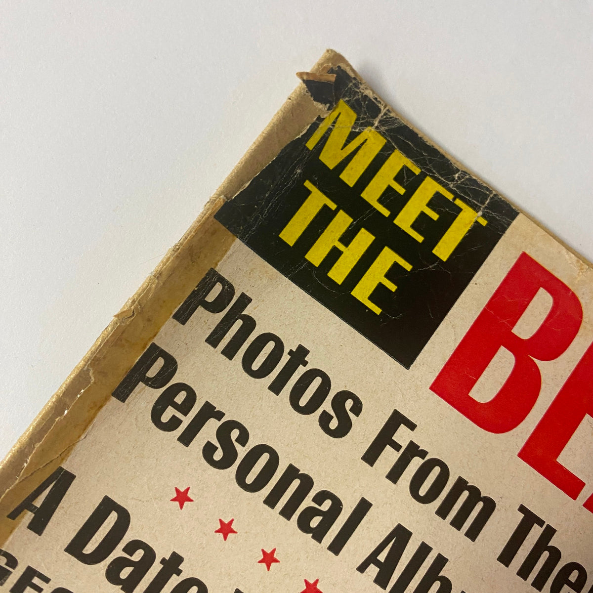 Close-up of the top corner of the 1963 Meet The Beatles magazine cover, highlighting the title "MEET THE" and the red text emphasizing the band's iconic name.