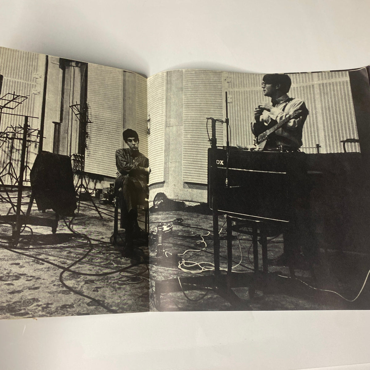 1964 Beatles USA Limited tour program book showcasing Paul McCartney speaking at a recording session, with a fellow band member seated nearby, capturing important moments from their historic music journey.