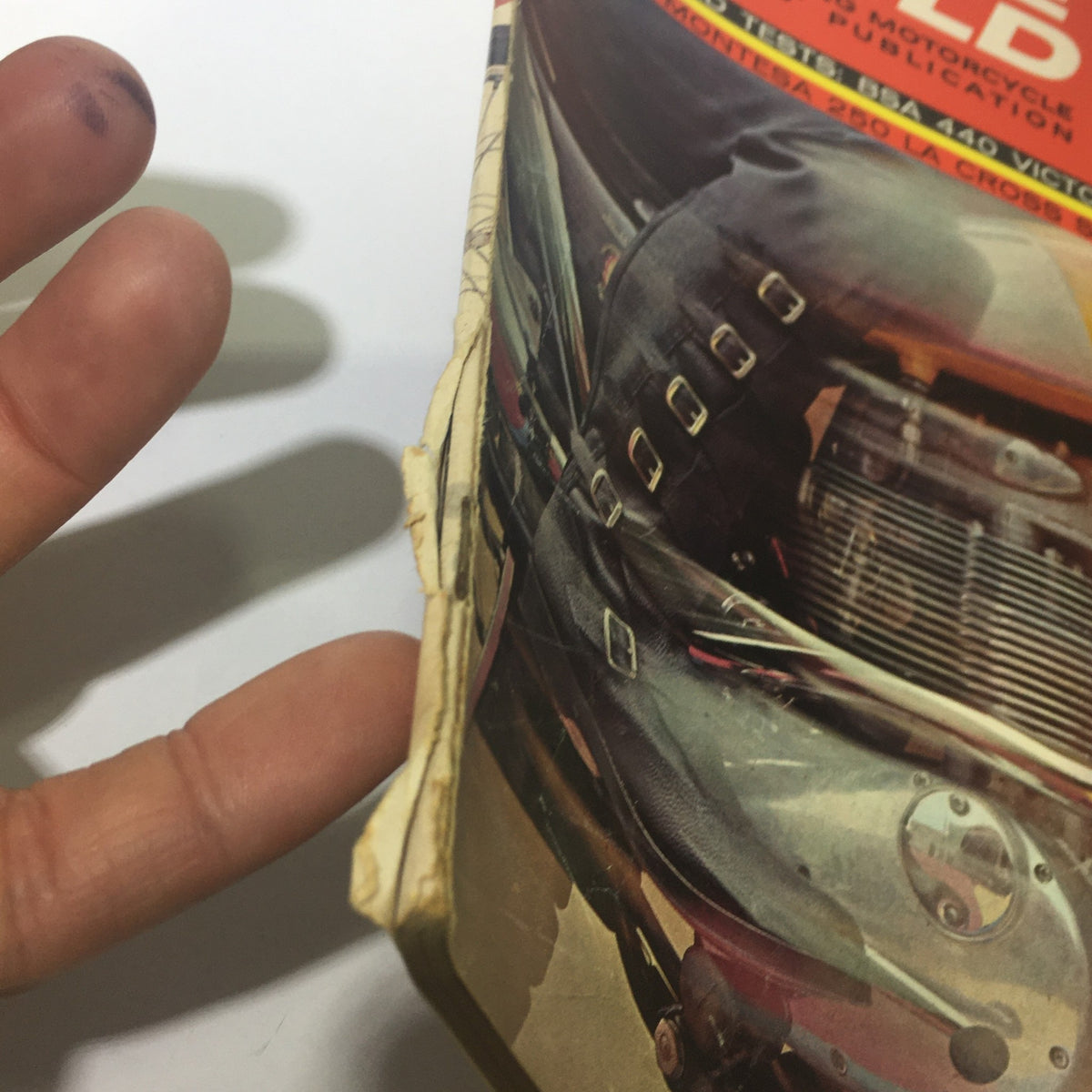 Close-up of the vintage Cycle World Magazine from April 1966, featuring visible wear on the edges and binding. This image highlights the magazine's condition, showcasing its historical significance alongside road tests of the BSA 440 Victor and Montessa 250.