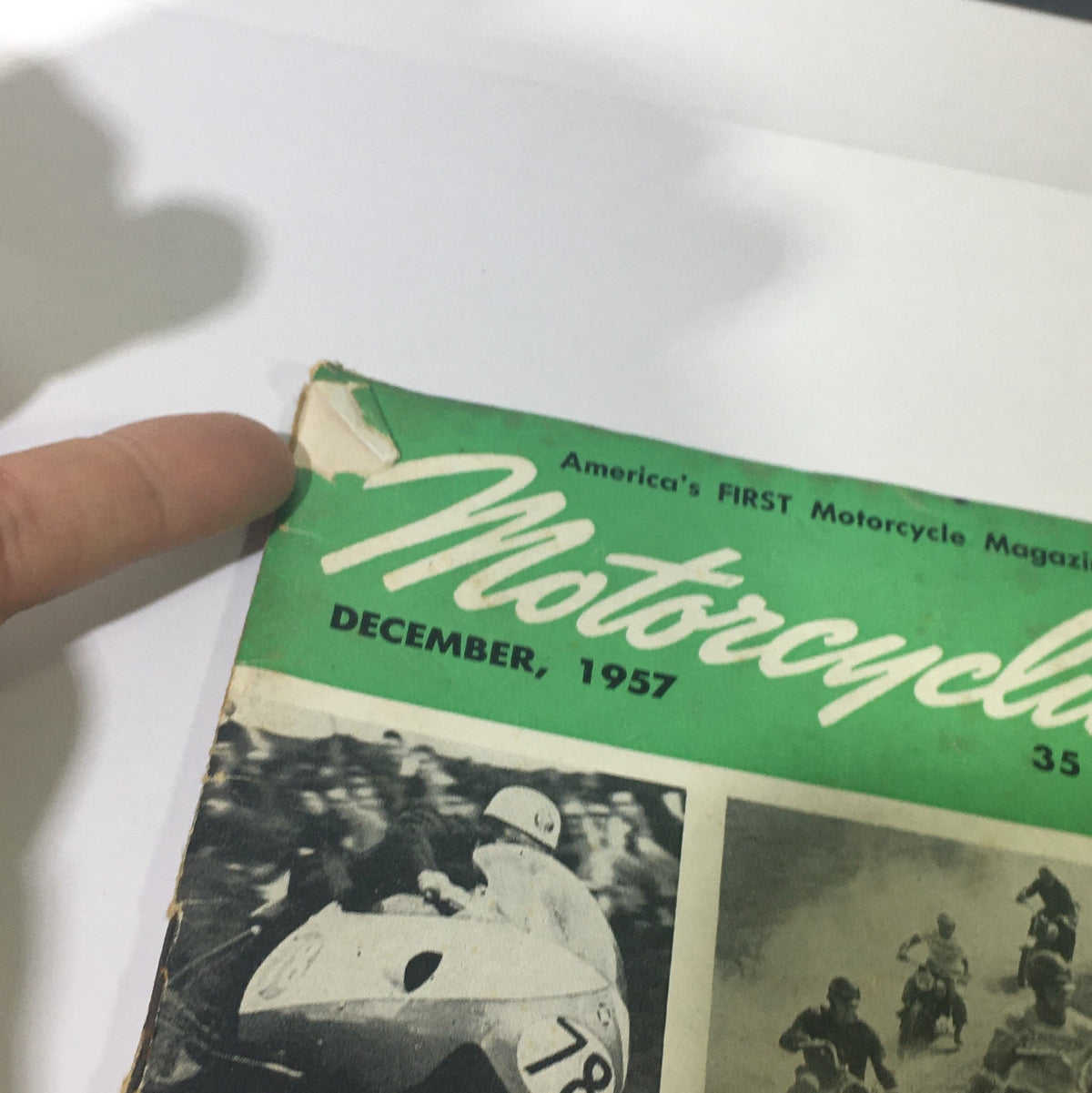 Cover of VTG Motorcylist Magazine December 1957 featuring motorcycle culture with a vintage design. The magazine highlights its title prominently and showcases a racing scene, making it a collectible item for enthusiasts.