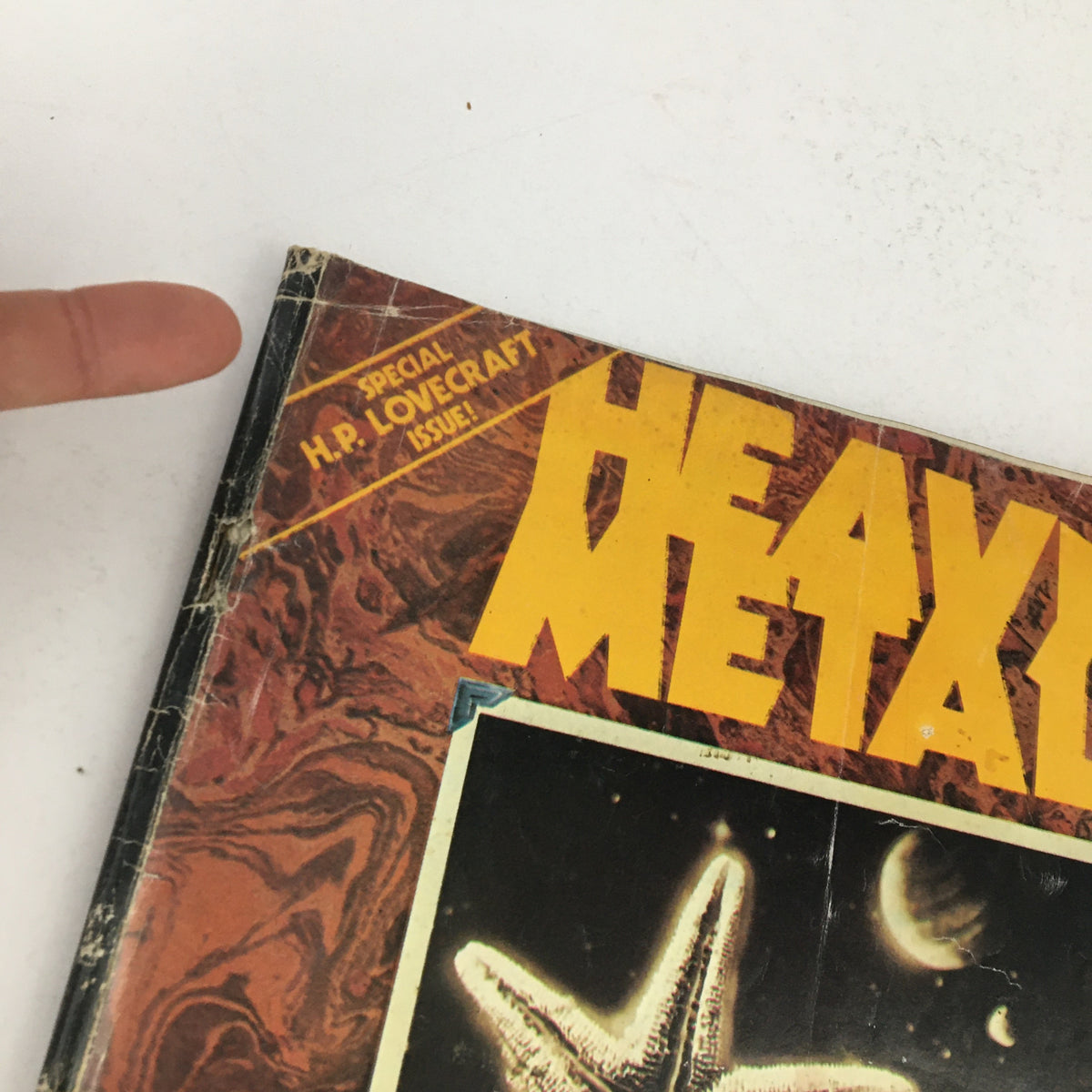 Close-up view of the Heavy Metal Magazine, October 1979, highlighting the special H.P. Lovecraft issue label and the distinctive cover art.