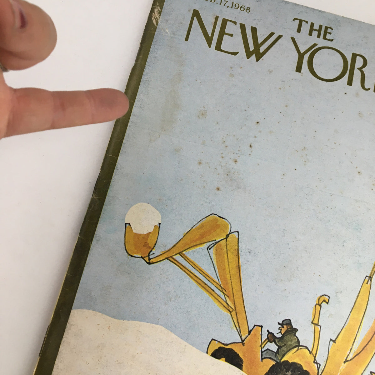 Close-up of The New Yorker Magazine February 17, 1968 cover by James Stevenson, highlighting the detail of the whimsical snowplow-like vehicle and the artist's signature, ideal for vintage magazine enthusiasts.