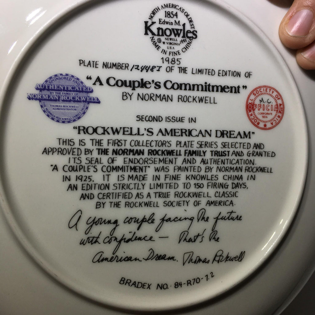 Back view of the 1985 A Couple's Commitment by Norman Rockwell Collectible Plate #12448I, showcasing its authentication seal and details.