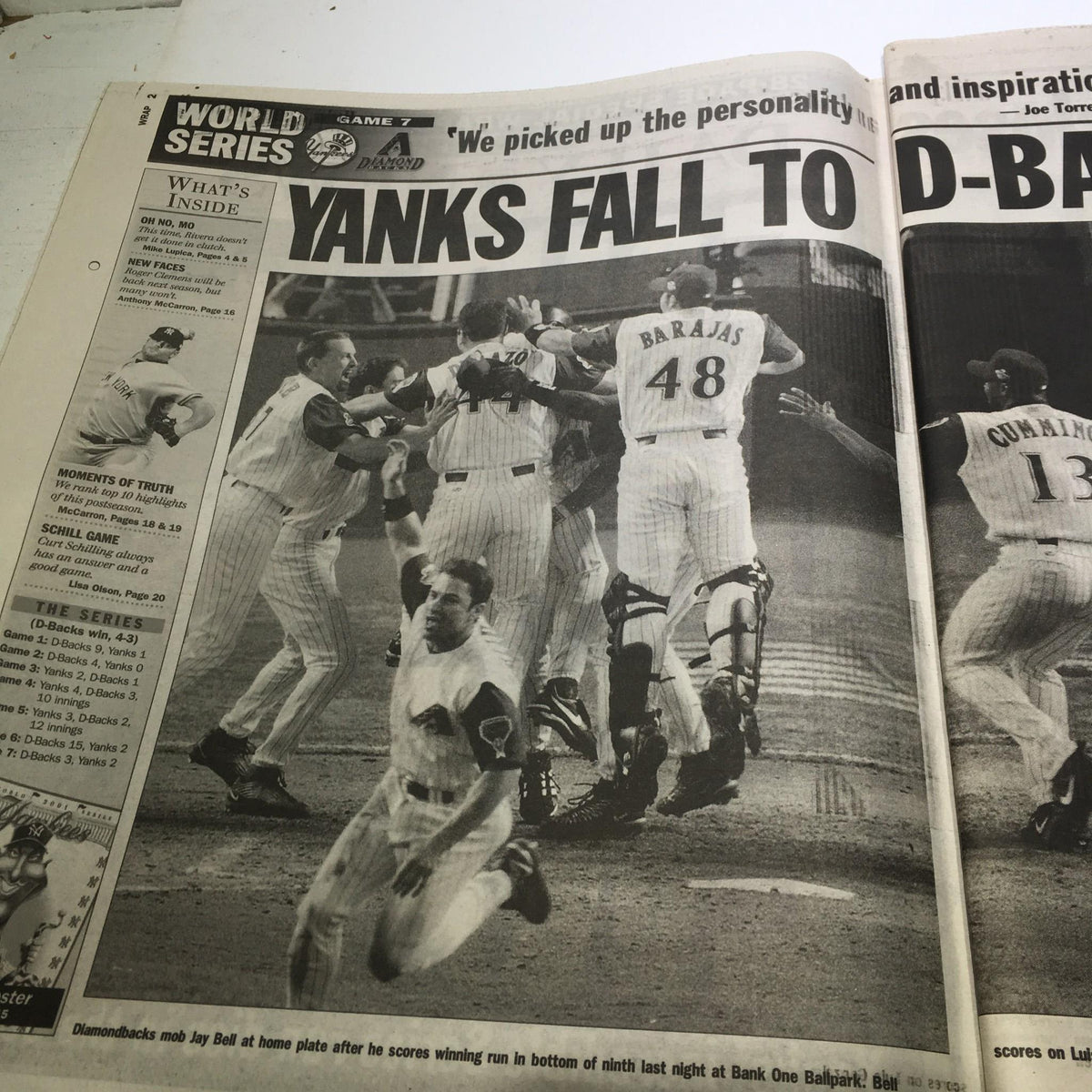 NY Daily News 11/5/01: Image of Yankees players celebrating after a game, illustrating the moment in the article titled 'End of An Era: Yanks Incredible Series Run Dies in Desert'.