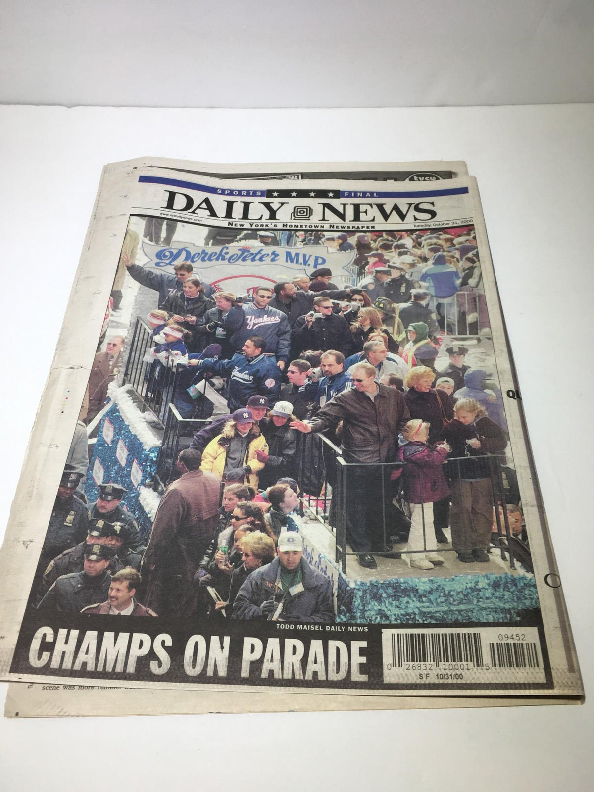 NY Daily News October 31, 2000 edition with the title 'CHAMPS ON PARADE!', depicting a crowd celebrating a victory.