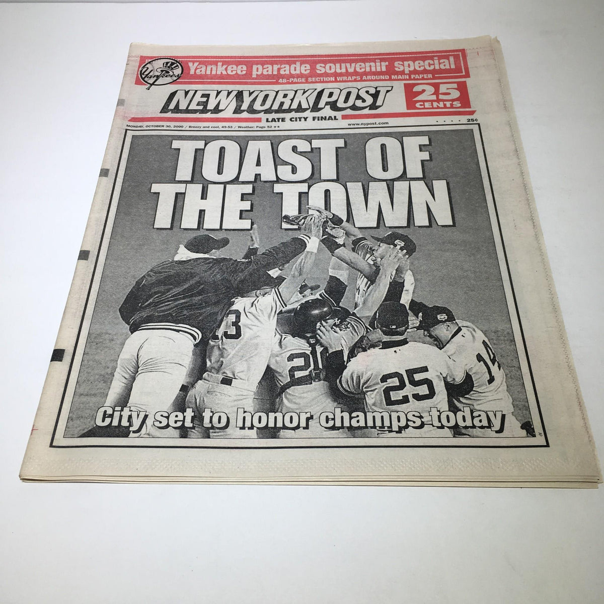 New York Post headline from October 30, 2000, titled 'Toast of the Town', featuring a celebration scene of a championship team. The newspaper highlights the city's honor for the champs.