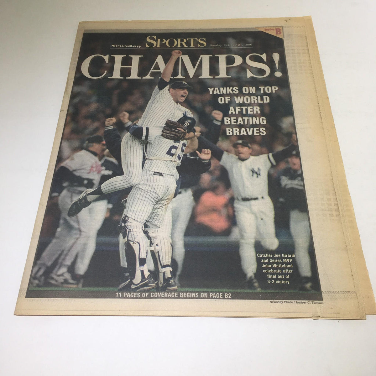Newsday October 27, 1996 cover featuring 'Champions! Yanks On Top of World After Beating Braves' with a celebratory image of the New York Yankees team, highlighting catcher Joe Girardi and pitcher Mike Stanton.