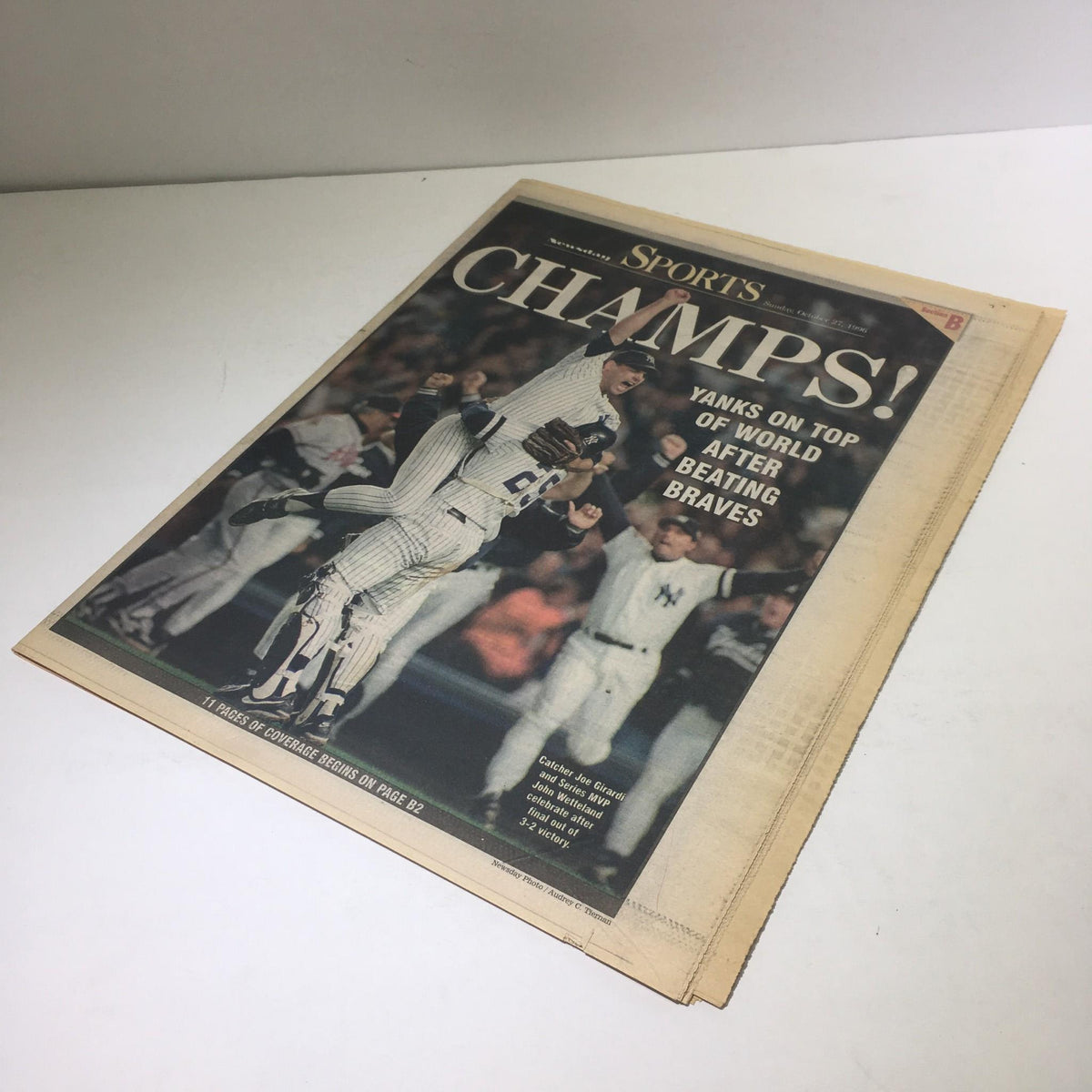 Cover of Newsday Sports section proclaiming 'CHAMPS!' with the headline 'Yanks On Top of World After Beating Braves' dated October 27, 1996, showcasing the excitement of the championship victory.