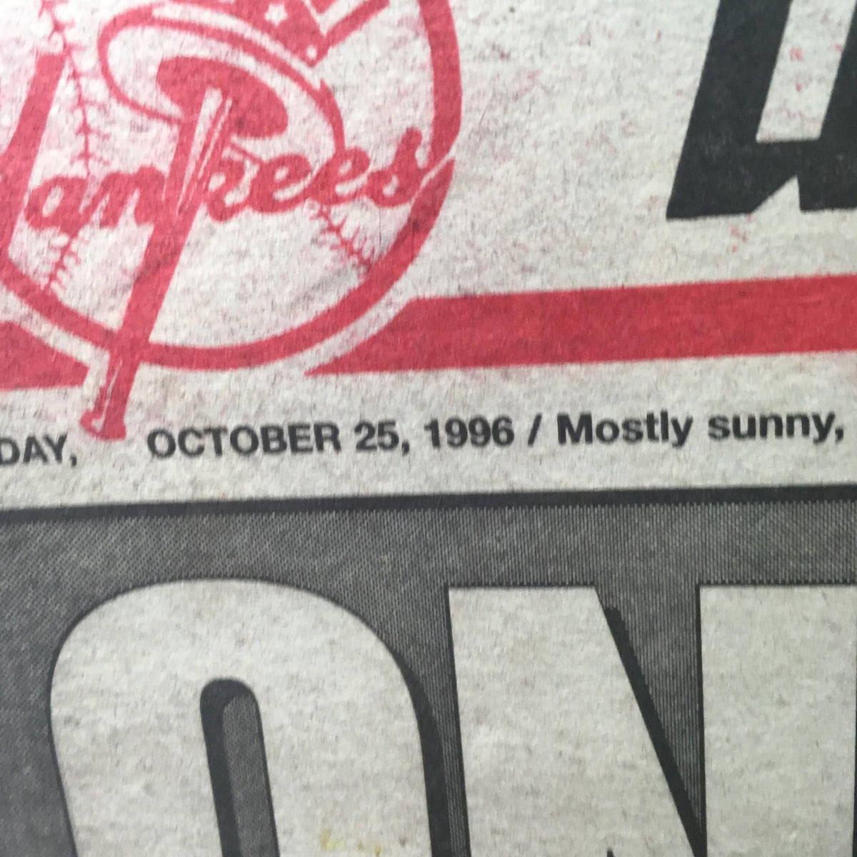 Close-up of the New York Post: Oct 25 1996 One Mo' Time newspaper, highlighting the date and Yankees logo, emphasizing its significance in sports history.