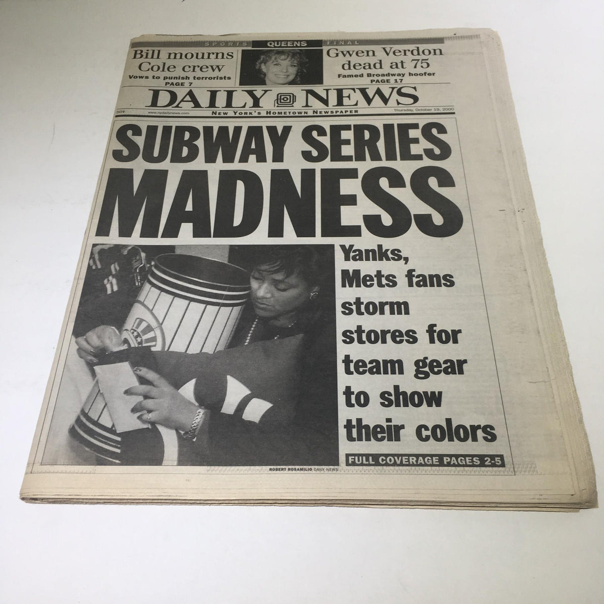 NY Daily News headline from 10/19/2000 showing fans storming stores for Yankees and Mets team gear to display their colors, emphasizing Subway Series excitement.
