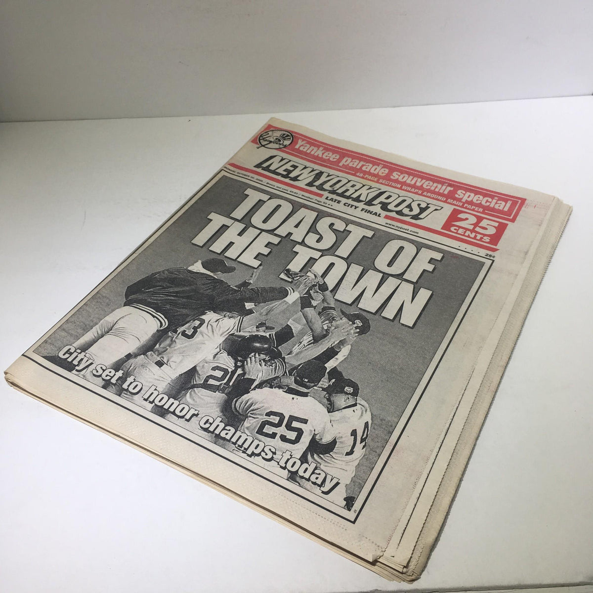 Another view of the New York Post showing the headline 'Toast of the Town' from October 30, 2000, with images of jubilant players celebrating their championship win.