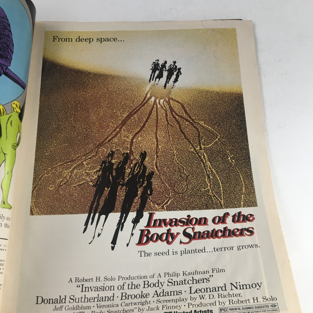 Image from Heavy Metal Magazine January 1979 featuring a retro advertisement for the movie 'Invasion of the Body Snatchers' illustrating suspenseful themes of sci-fi and horror.