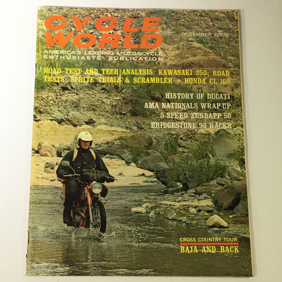Cover of VTG Cycle World Magazine December 1966 featuring a rider on a motorcycle crossing a stream, showcasing the Kawasaki 250 and Sprite Trial & Scrambler, highlighting motorcycle culture and trends of the 1960s.